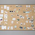 Corkboard Photo Wall Displaying Photos Notes and Papers on Neutral Background