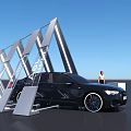 Black Sedan Car Display With Modern Geometric Metal Structure And Standing Person Under Blue Sky