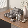 Gray Rolled Towels on Wooden Table with Aromatherapy Candles and Decorative Items