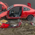 Red Damaged Car With Crashed Front End Open Hood And Broken Glass