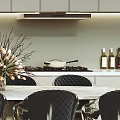 Modern Restaurant Dining Area With White Table Black Chairs Flower Arrangement And Wall Art