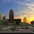 Red Brick School Building with Clock Tower Central Plaza Benches and Greenery Under Sunset Sky
