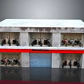 Honda Motorcycles Displayed in Two Story Building With Red Signboard and Windows