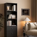 Modern Black Bookcase With Stacked Books Framed Art Table Lamp Near Sofa And Plant