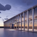 Modern Building With Glass Curtain Wall At Dusk Overlooking Sea View