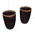 Two Black Cylindrical Ceramic Vessels with Brown Rimmed Accents on White Background