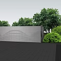 Modern Perforated Metal Fence In Outdoor Area With Green Trees And Paved Surfaces