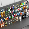 Various Beverage Bottles Neatly Arranged On Black Table With Different Colors And Sizes