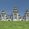 Ornate Traditional Entrance Gate With Intricate Stone Carvings And Tiered Towers Design