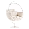 Round Golden Frame Hanging Chair With White Cushions And Gray Blanket