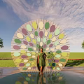 Vibrant Circular Landscape Sculpture With Colorful Green Purple Blue Leaves In Grass Field And Trees