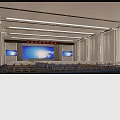 Large Modern Conference Room With Multiple Blue Screens Arranged Seats And Ceiling Lighting