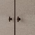 Elegant Brass Door Handles Mounted On Beige Textured Fabric Cabinet Panels