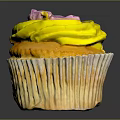 Appetizing Cupcake With Yellow Frosting And Purple Decoration On Ruffled Paper Liner