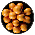 Fresh Ripe Juicy Oranges Arranged in a Black Bowl on White Background