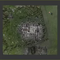 Ancient Ruin Structure On Green Grass With Square Foundation And Scattered Stones
