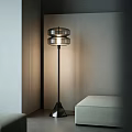Modern Floor Lamp With Transparent Glass Shade And Black Metal Stand In Minimalist Room