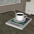 Rich Black Coffee in White Cup on Gray Table with Silver Spoon and Colorful Magazine