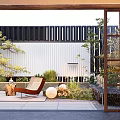Courtyard Garden With Outdoor Lounge Chairs Lush Green Plants And Stone Paving