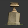 Decorative Stone Urn With Ornate Top On Square Pedestal In Green Grass