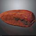 Red Cocoa Pod With Textured Surface And Dark Spots On Black Background