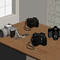 Various Vintage and Modern Cameras with Straps on Wooden Table Top