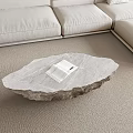 Natural Stone Irregular Coffee Table With Open Book On Beige Carpet In Living Room Sofa