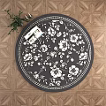 Round Rug with Black and White Floral Pattern on Wooden Floor