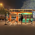 Night Outdoor Colorful Food Stalls with People Gathering Near Trees and Buildings