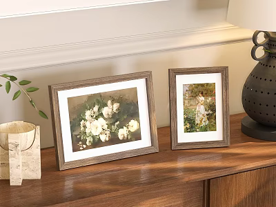 Two Picture Frames with White Flower and Child Art on Wooden Cabinet with Green Plant 3d model