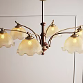 Vintage Glass Chandelier with Scalloped White Shades and Brown Metal Frame Hanging in Light Room