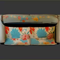 Spacious Vintage Sofa With Curved Armrests Colorful Floral Cushions And Light Wooden Legs