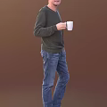Man Wearing Dark Green Sweater And Blue Jeans Holding White Mug Against Brown Background