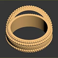 Two Stylish Gold Fashion Rings With Intricate Textured Patterns On Black Surface