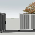 Dark Gray Metal Gate With Vertical Slats And Autumn Tree In Yard