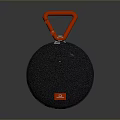 Portable JBL Computer Speaker With Black Circular Body Red Hook And Textured Surface