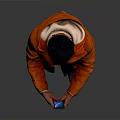 Man in Orange Jacket With Bandana Holding Phone Against Gray Background