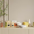 Ceramic Ware Display With White Plates Yellow Bowls On Light Wooden Countertop