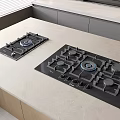 Modern Kitchen Interior With Black Gas Cooktops Light Countertop And Gray Cabinets
