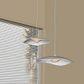 Modern Pendant Lights With Wavy Design Above Window With Blinds Soft Glow In Interior Space
