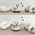 White Curved Sofa And Round Coffee Table Set With Armchair Decorative Items On Rug