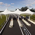 Garden Landscape With White Membrane Structure Green Lawn And Trees Along Roadway