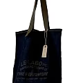 Stylish Dark Blue Canvas Tote Bag Pendant with Leather Handles and Manufacturer Text Label