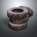 Three Stacked Tires With Dark Rusty Tread Pattern Against Gray Background