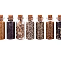 Assorted Spice Bottles with Cork Stoppers and Transparent Glass Containing Various Spices