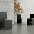 Modern Black Leisure Chairs In Interior With White Brick Wall And Yellow Leaf Plant