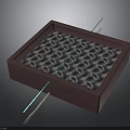 Red Square Box With Silver Ring Pattern And Metal Needles Arranged