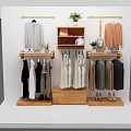 Wooden Clothes Hangers Display With Various Hanging Clothes Potted Plants And Shoes On Shelves