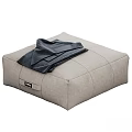 Light Gray Tufted Ottoman With Dark Gray Blanket And Soft Linen Fabric