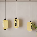 Japanese Style Pendant Lights Featuring Yellow Lampshades And Japanese Characters With Green Plant
